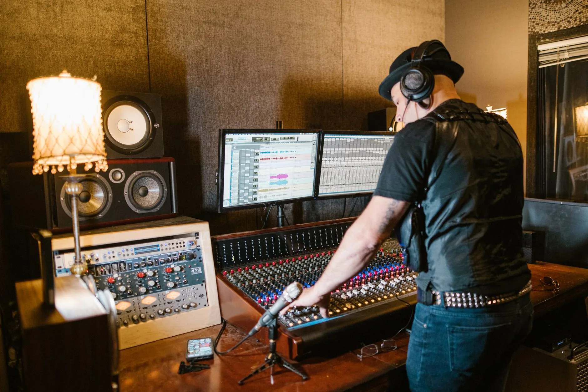 Vintage recording studio, dimly lit, with a warm glow, showcasing early music song recordings and listening.
