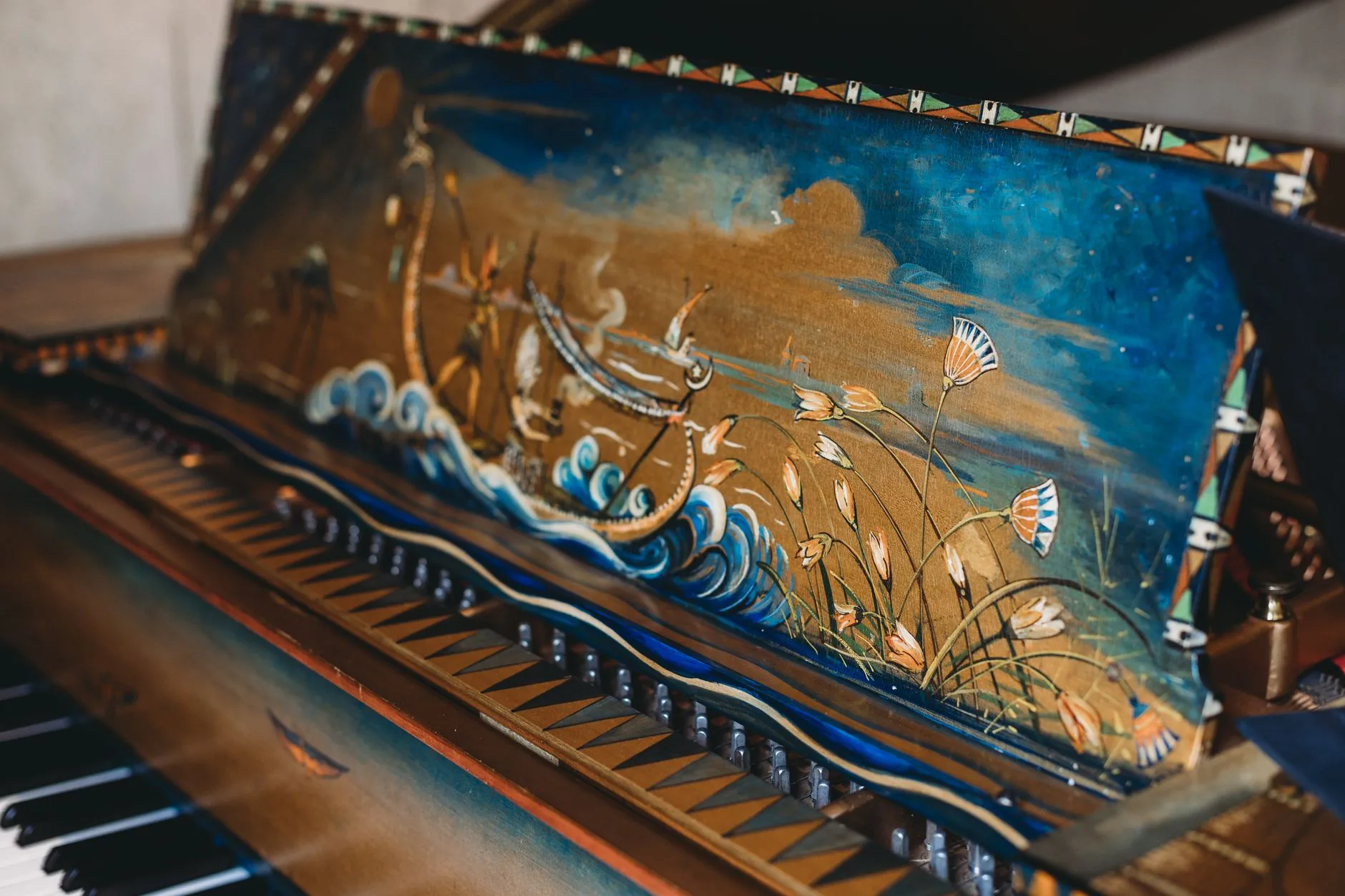 A vintage hurdy-gurdy with polished wood and strings, displayed for sale, medieval string instrument.